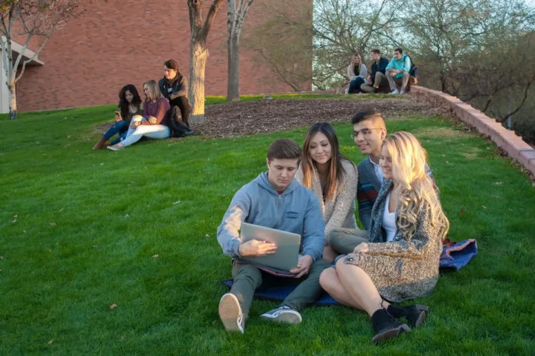 students looking at laptop together