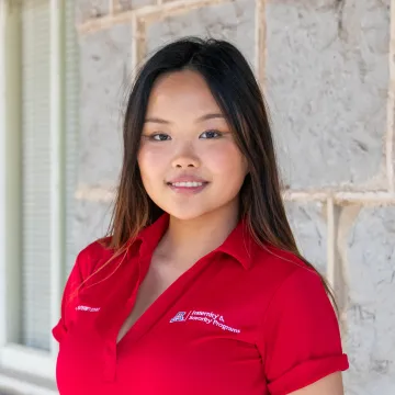 Emma Posing in a red polo shirt. 